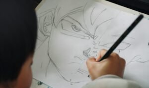 Child drawing a character with a pencil on paper