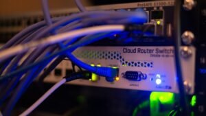 Close-up of network cables connected to server equipment, illustrating AI agents operating across online systems