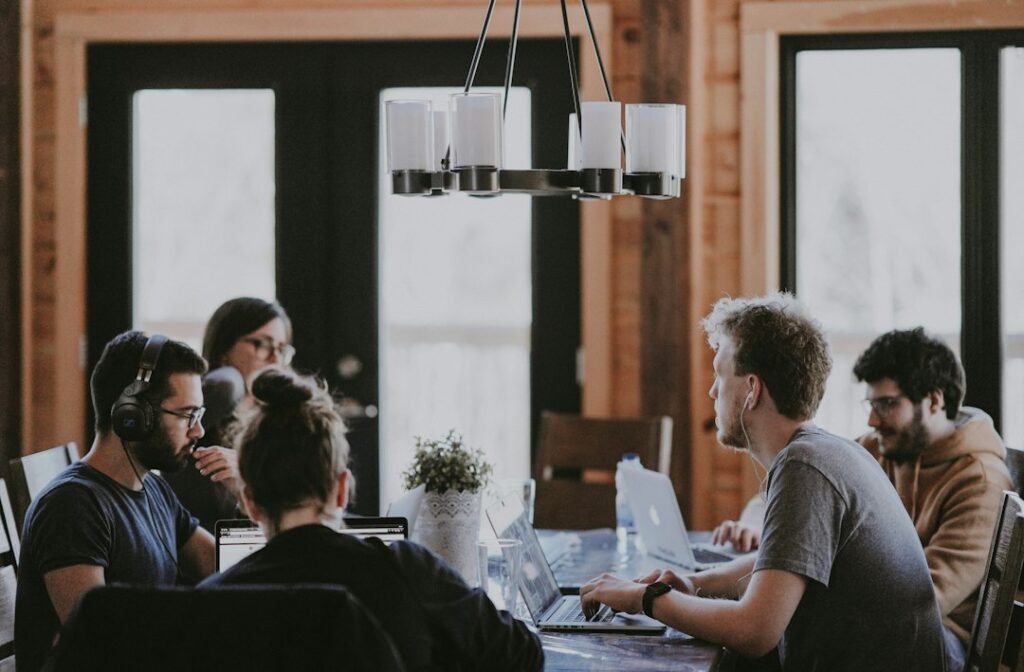 Coworkers sitting around a table in an office