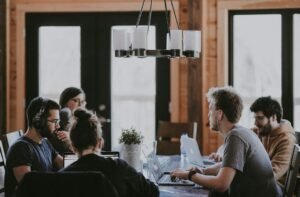 Coworkers sitting around a table in an office