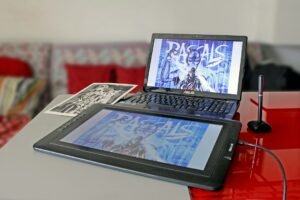 Designer's tablet and laptop on a desk