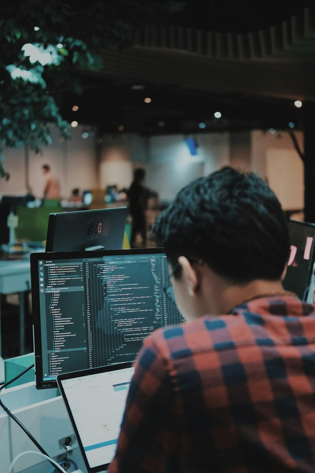 Developer writing code on a computer in a workspace