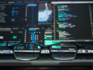 Eyeglasses in front of a screen showing website code