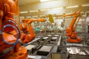 Factory floor with rows of orange industrial robots