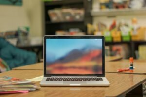 Laptop on a wooden table in a workspace