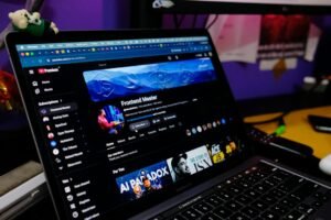 Laptop showing a YouTube channel page, illustrating YouTube automation with AI for creators