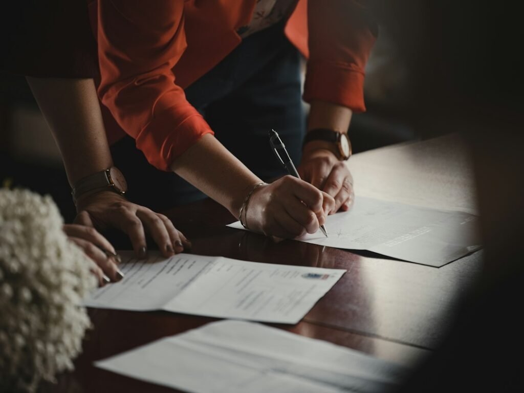 Person reviewing and signing a legal document