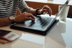Person seated at a table using a laptop