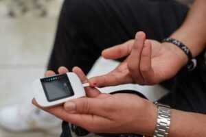 Person testing blood glucose with a glucometer