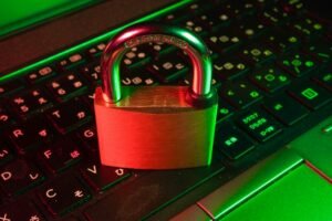 Red padlock on a black computer keyboard