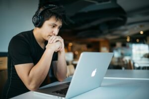 Remote worker wearing headphones at a laptop