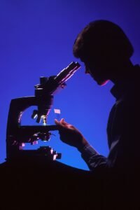 Researcher using a microscope in a laboratory
