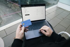 Small business owner with a laptop and a payment card