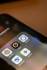 Smartphone screen showing AI assistant app icons including ChatGPT, Meta AI and Gemini, representing the competitive AI agent app market