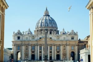 St Peter's Basilica dome in Vatican City under a blue sky