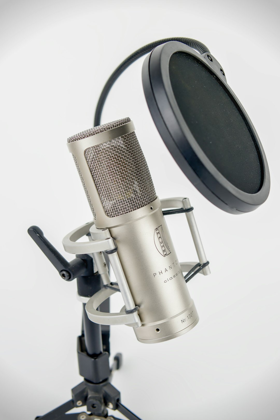 Studio microphone with a pop filter, used when recording or replacing AI voiceovers for YouTube videos