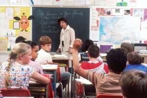 Teacher standing in front of students in a classroom