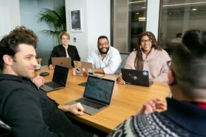 Team on laptops listening during a meeting