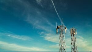 Telecommunications tower with antennas under a blue sky