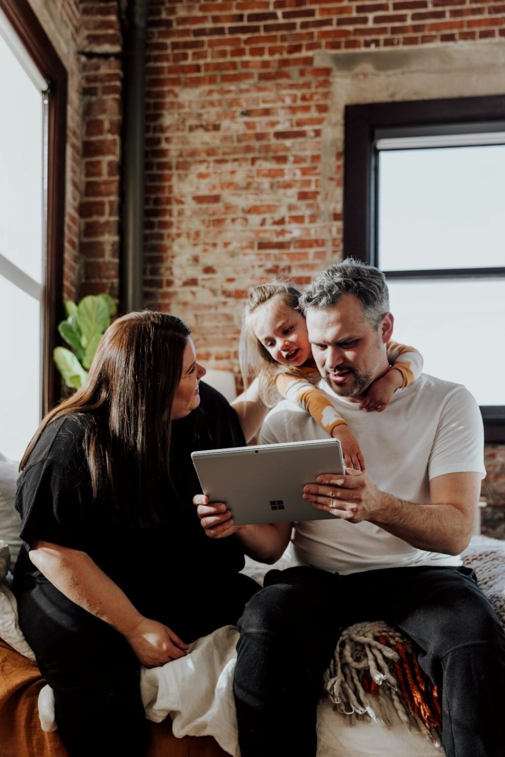 Three people looking at a tablet together
