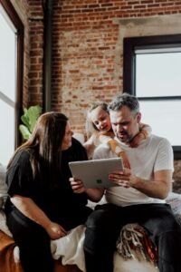 Three people looking at a tablet together