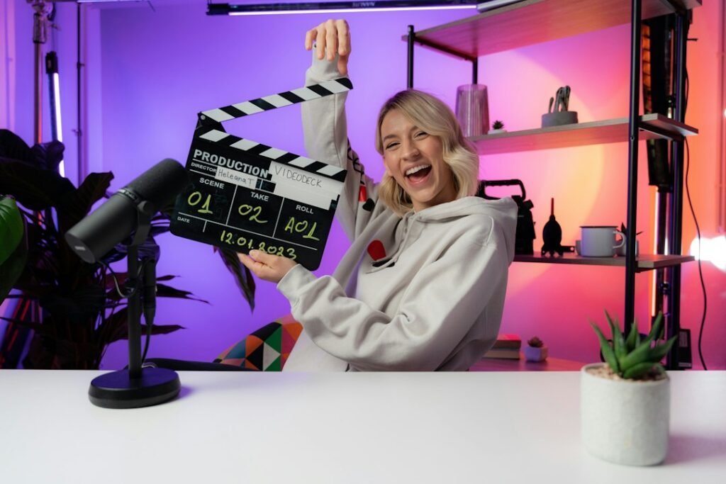 Video creator holding a clapperboard in front of a camera