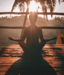 Woman meditating on a wooden floor