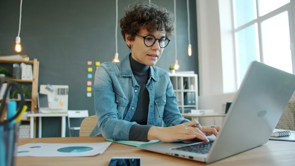 Woman working on a laptop in a modern office