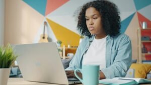 Young woman studying on a laptop at home