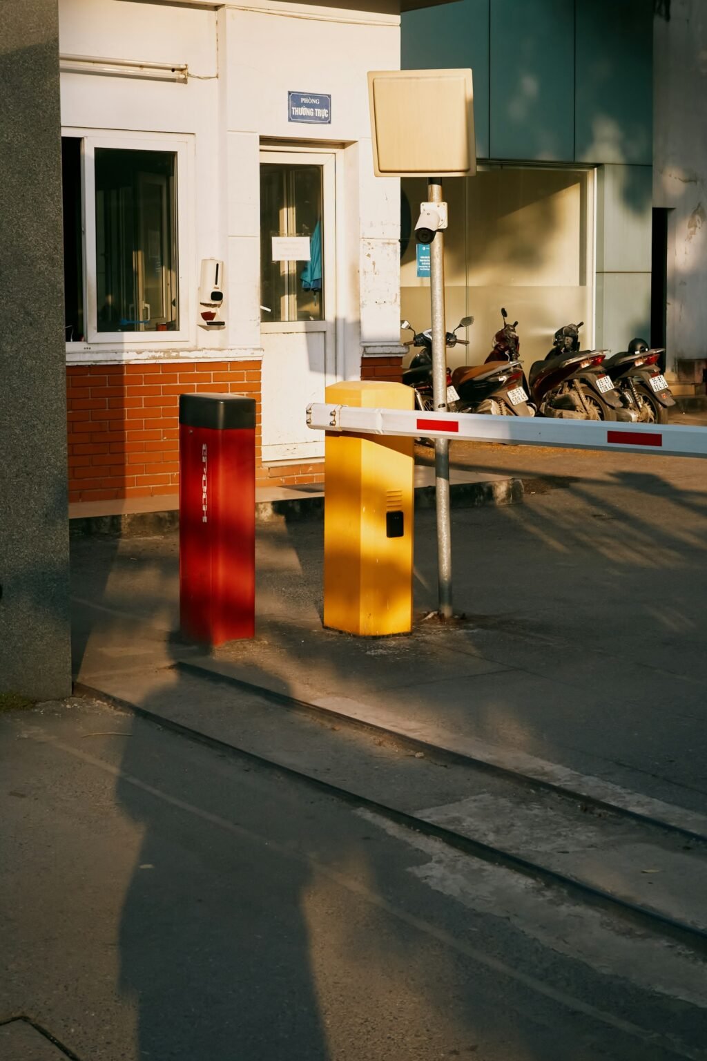 Barrier gate with red and yellow bollards, representing AI agent security controls and least-privilege access