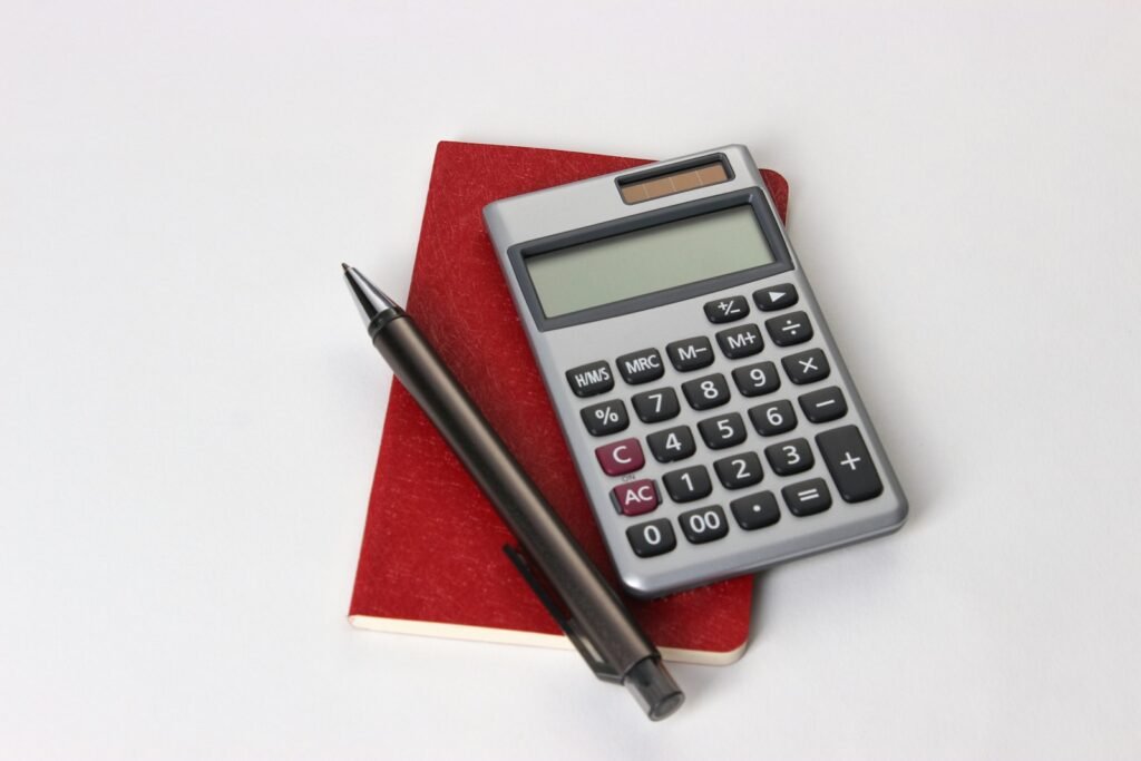 Black and silver calculator beside a pen, illustrating Perplexity pricing and plan costs