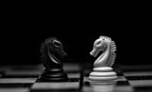 Black and white chess knights facing each other, representing Gemini 4 Argon vs Claude Opus 5.5