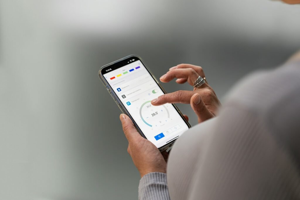 Hands holding a smartphone with an app open, like using the Meta Muse personal AI agent