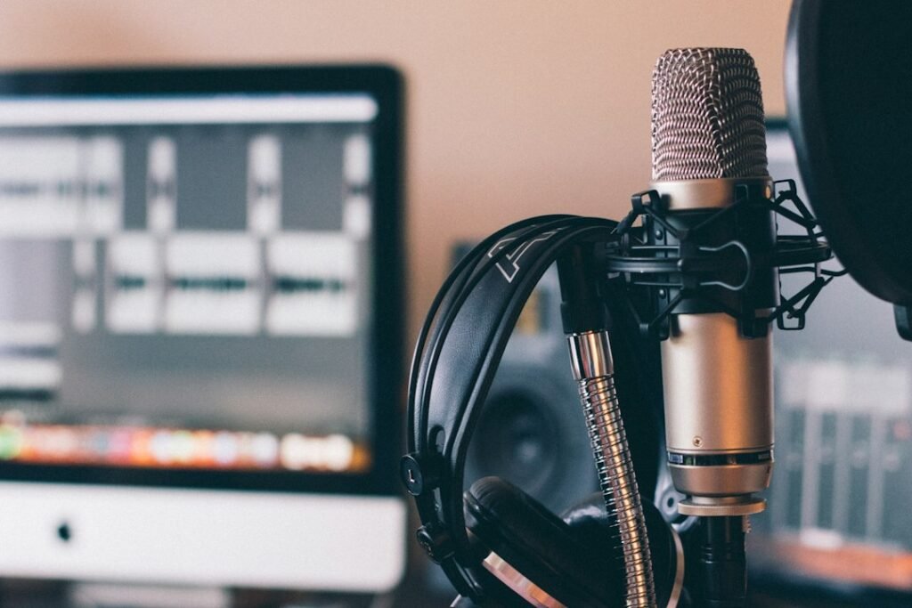 Headphones resting on a studio microphone, illustrating how to use ElevenLabs to create AI voiceovers without recording equipment