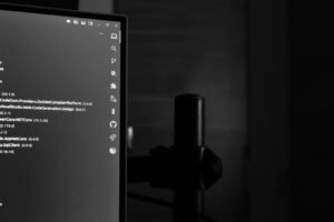 Monitor showing code in a dark room, illustrating OpenCode vs Claude Code terminal coding agents