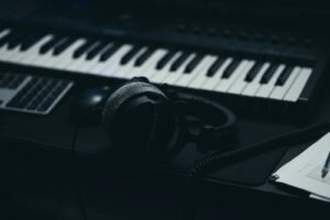 Music keyboard with headphones and a microphone, representing AI music on YouTube and its new labels