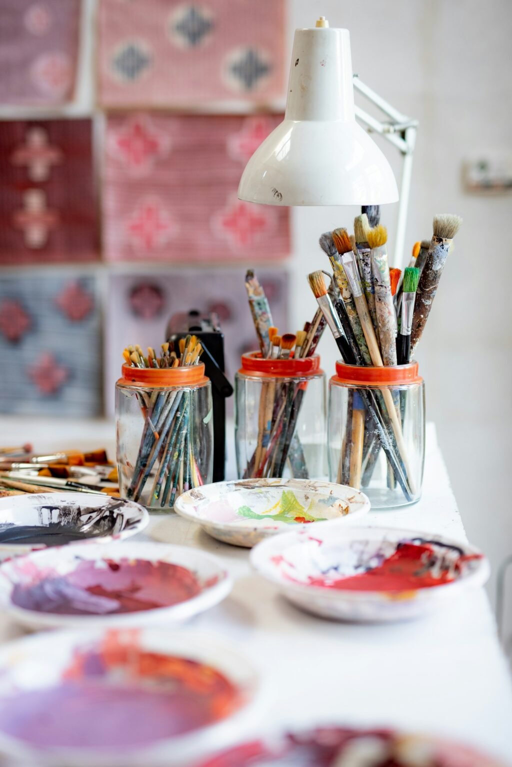 Paint brushes on a ceramic plate, representing the Nano Banana vs Midjourney image generator comparison
