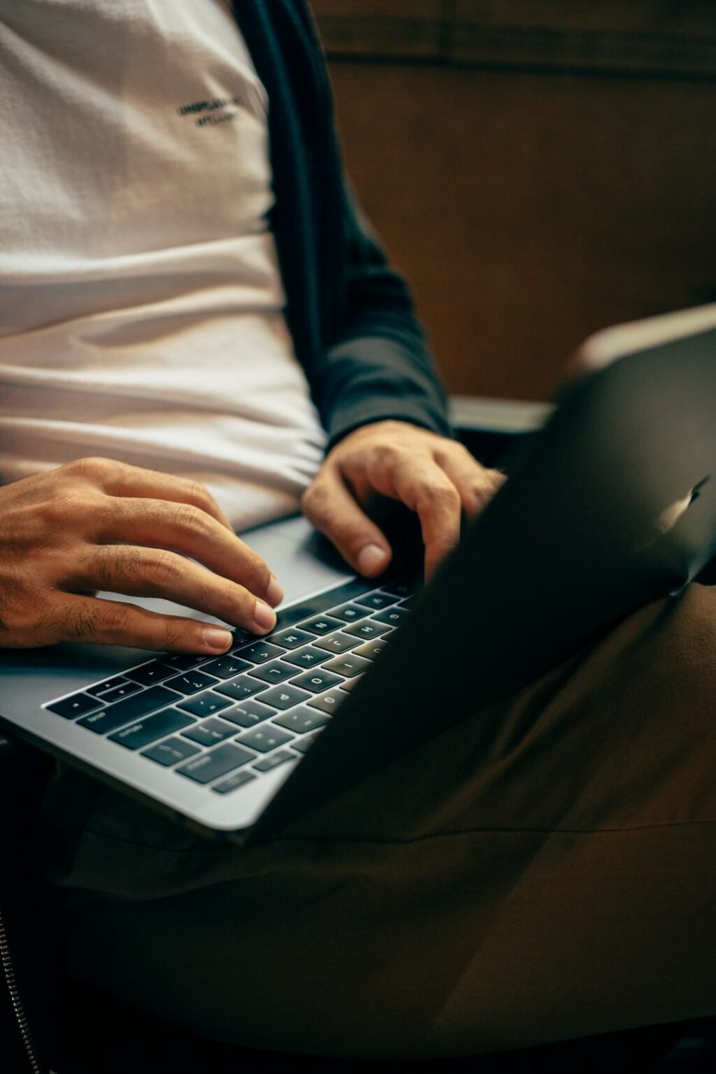 Person typing a prompt on a laptop, illustrating how to use Gemini Skills to reuse saved instructions with a slash command