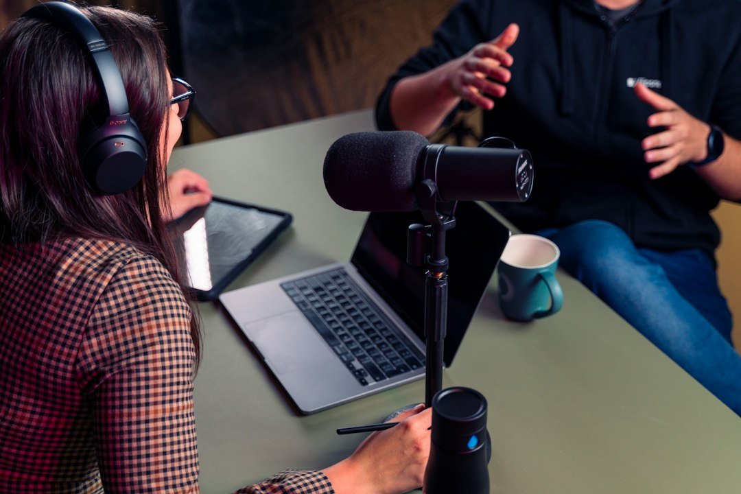 Person wearing headphones at a laptop, reviewing an ElevenLabs v4 text-to-speech voiceover before exporting it