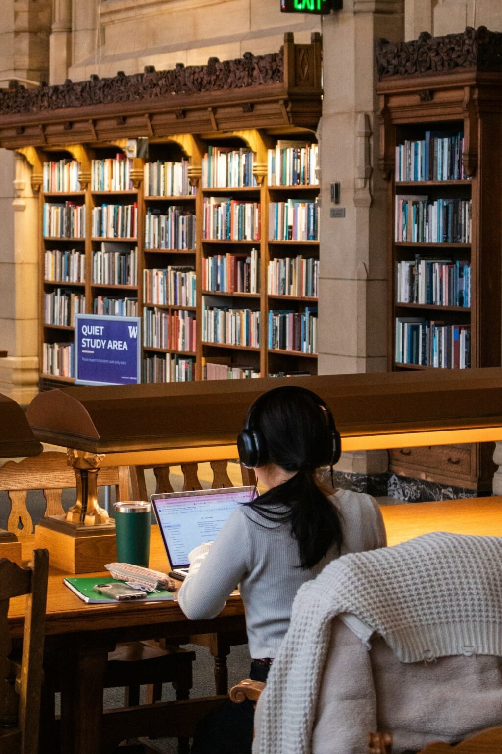 Woman studying in a quiet library, representing NotebookLM alternatives for research and study