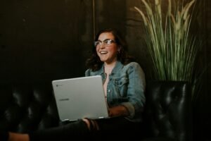 Woman using a laptop for a video call, illustrating how to use Tavus AI conversational video